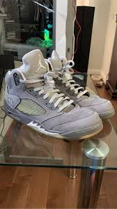 Air Jordan 5 Retro sneaker in wolf grey colorway, displayed against a neutral background